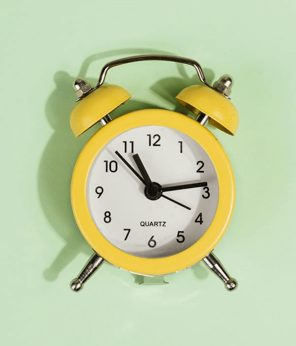 This example swaps the frame color of a classic alarm clock from yellow to bright orange. The tool sets the yellow color as the source color using the hex code #DAB62E, including 20% of similar shades, and swaps it to the orange color #FF6D00. Since the alarm clock has a convex shape that creates volume and shadows, the program activates the "Maintain Color Brightness" option to preserve light reflections and brightness variations in the new color. (Source: Pexels.)