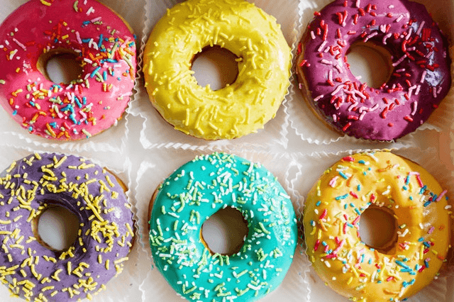 In this example, we load a PNG file with a box of colorful donuts and apply the reflection along a horizontal line that goes through the center of the box. The horizontal line is drawn at the position y = 207 and it reflects the bottom donuts upwards. Now we have two rows of donuts of the same color at the top and bottom. (Source: Pexels.)