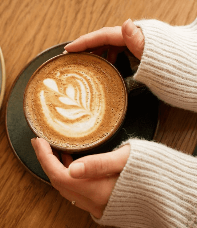 In this example, we transform a cup of coffee photo in PNG format into a cozy polaroid snapshot. We add a thick white frame and a two-line caption, "Little moments, big warmth.", at the bottom. The caption is set in Trebuchet MS font, made bold, and centered. To give it a more natural feel, we rotate the polaroid by 15 degrees and add a custom shadow with a horizontal offset of -30 and a vertical offset of 30, making it appear as if the photo is casting a shadow behind it from the light source. (Source: Pexels.)