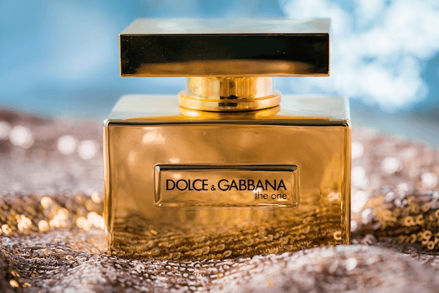 In this example, we delete the brand name that's printed on a PNG image of expensive perfume. We overlay the rectangular area over the logo in the preview field and delete the pixels in this region by overwriting them with a single solid color "#b36f26", which matches the gold color of the perfume bottle. (Source: Pexels.)