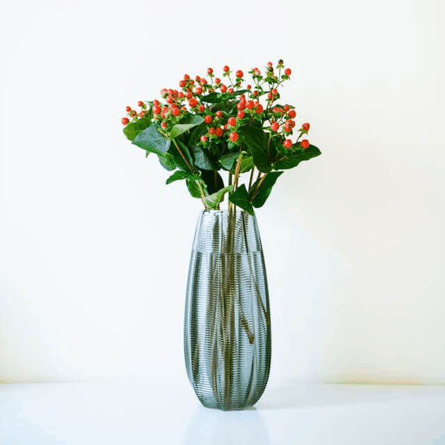 In this example, we create a decorative stamp from a JPG photo of a flower vase. We switch to the circular cropping mode and select a round 600×600 pixel area of the JPG. To preserve the maximum artistic detail and texture, we enable the dithering option using the Atkinson's method. Around the border, we add an extra 20 pixels of padding, giving the edges some space. Additionally, we style the stamp with two colors – dark green for the vase and flowers and dark blue for the circular border. (Source: Pexels.)