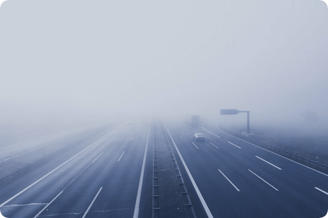 This example loads a PNG photo of a foggy highway and rounds all of its corners with a radius of 20px. The part of the corner that was rounded and removed is replaced by a transparent color. (Source: Pexels.)