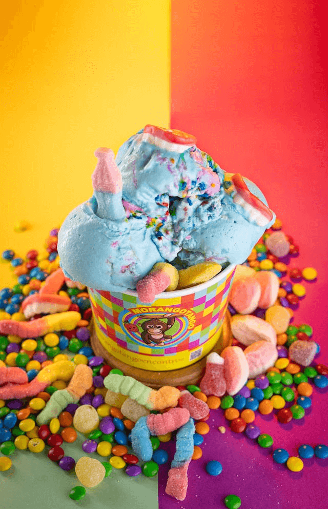 In this example, we upload a vibrant PNG image of an ice cream covered in gummy worms and Skittles. We select the right half of the PNG by dragging the rectangular shape over it and positioning it at 332 pixels from the left. Then, we apply the color reversal effect inside this shape. As a result, the pink-red background turns into a blue-green background and the milk ice cream in the cup turns into chocolate ice cream. (Source: Pexels.)