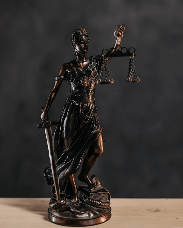 This example transforms an image of the Lady Justice statue into a professional-looking stamp. The stamp's design features a practical circular shape and is decorated with a black border made of a sequence of stars. The interior of the stamp contains a simplified version of the statue, also painted in black color. This stamp is well-suited for use by law firms, notaries, or legal departments aiming to reflect the values of justice and law in their branding. (Source: Pexels.)