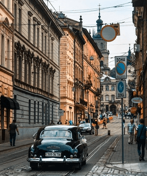 In this example, we split a PNG image of a city street into two parts. We leave the right part as it is and make the left part have 100% sepia tones. As a result, we get a half-retro, half-modern photo of the same street that looks like it was taken in different centuries. (Source: Pexels.)