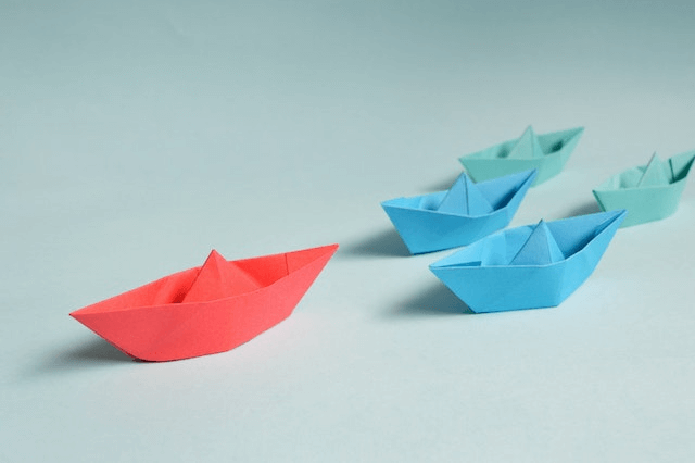 This example finds the red paper boat among boats of different colors. It uses the RGB color code "RGB(239, 49, 49)" to match the boat's red color and includes 20% similar shades of this color. In addition, it smoothes the pixels around the boat with a 1px radius and draws the red boat on the misty-rose background. (Source: Pexels.)
