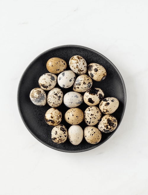 In this example, we remove the background only around the plate of quail eggs. The background color is light gray but this shade also appears in the spots on the quail eggs. To remove only the background pixels and keep the eggs opaque, we use the "Delete Outer Areas" option. This option removes only those background pixels that touch the edges of the image. (Source: Pexels.)