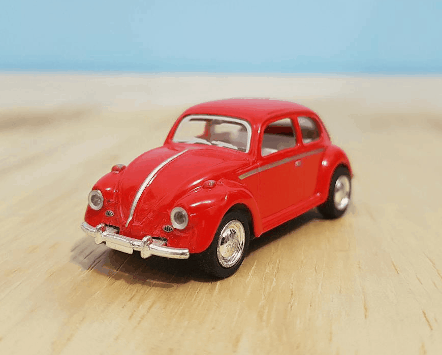 This example turns a single-frame, static GIF image of a red Volkswagen Beetle into a stamp resembling a postage mark. It tightly crops the image around the car, sets a rectangular shape, and adds a bold black spiky border around it. The stamp is colored black and its quality is reduced to 70%, giving it a slightly worn, imperfectly inked appearance. (Source: Pexels.)