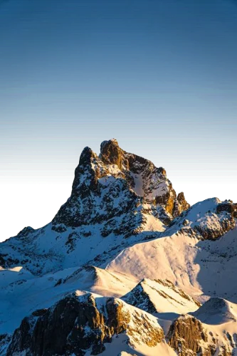 In this example, we visualize the alpha channel in custom colors. For the opaque pixels of the mountains (where α = 1), we use the color burlywood. For the fully transparent pixels just behind the mountains (where α = 0), we use the color steelblue. For partially transparent pixels (0 < α < 1) high in the sky and around the edges of the mountains, we use the color orchid, displaying the actual transparency level of each pixel. (Source: Pexels.)
