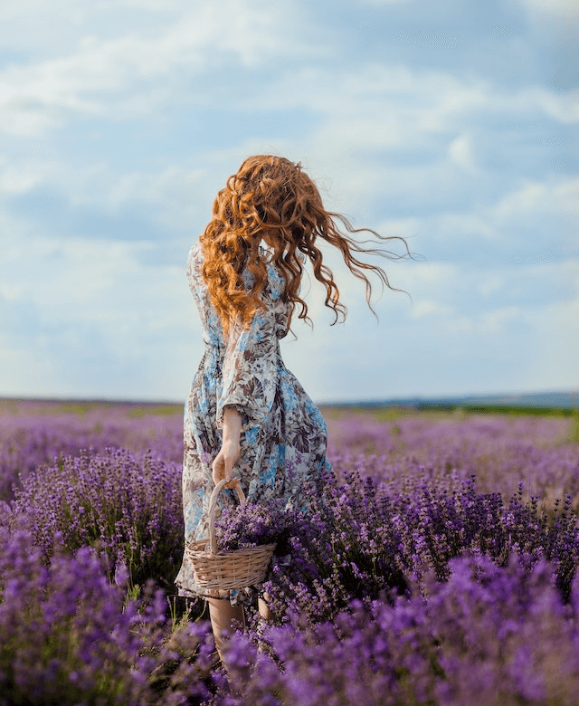In this example, we load a PNG image of a girl in a lavender field and turn it into a polaroid. We add a white 15-px border on the sides and a 50-px spacer at the bottom for the text. We add the caption "July 2022" to remind us the date of this unforgettable moment. (Source: Pexels.)